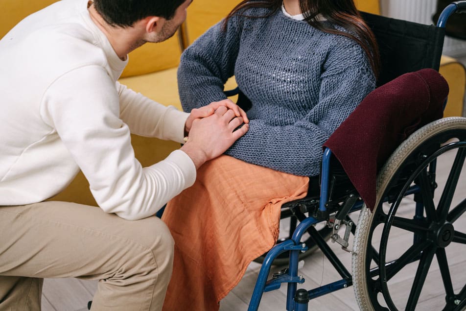 Photo of a career providing formal at home care and support to an adult in a wheelchair
